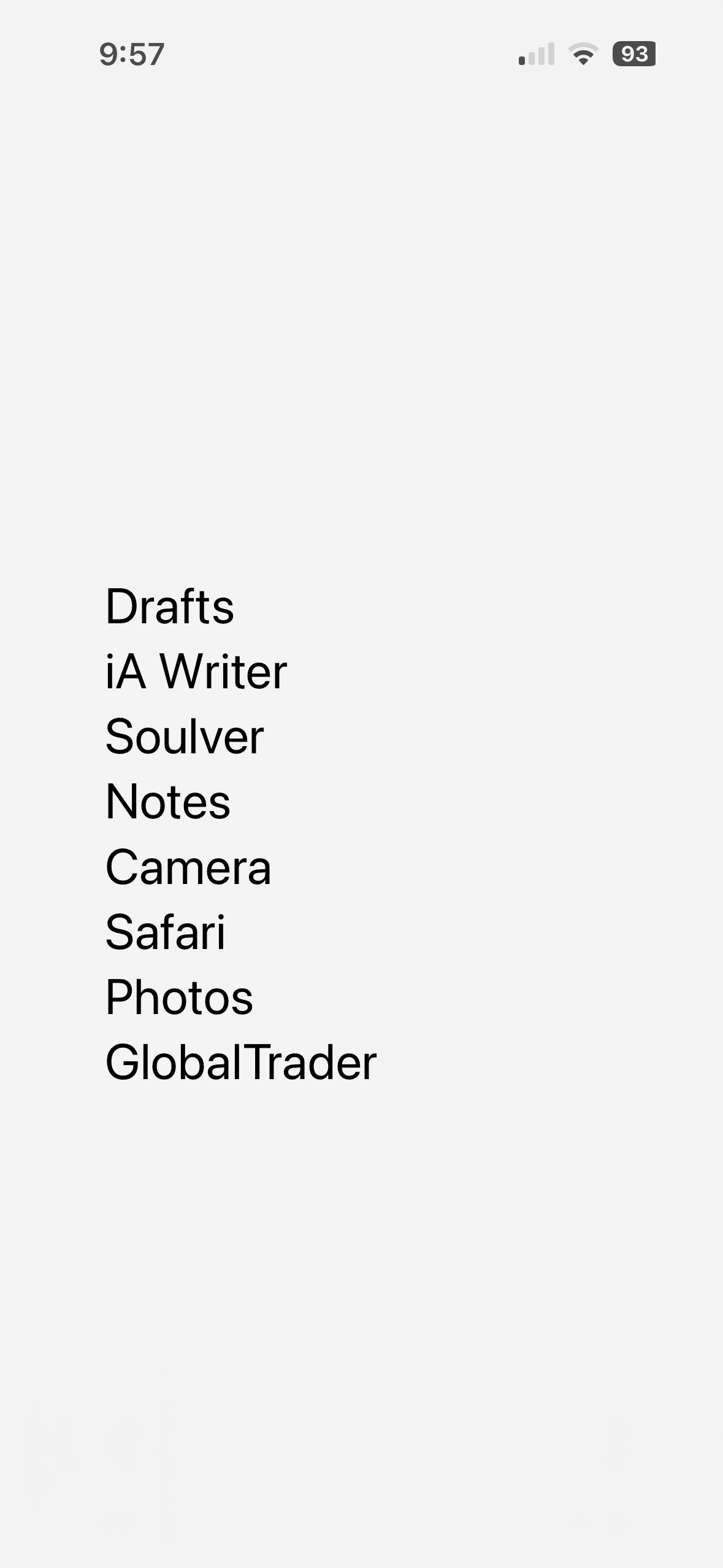 A smartphone screen displaying the time (9:57) and battery percentage (93%). Below, there’s a list of apps: Drafts, iA Writer, Soulver, Notes, Camera, Safari, Photos, and GlobalTrader.